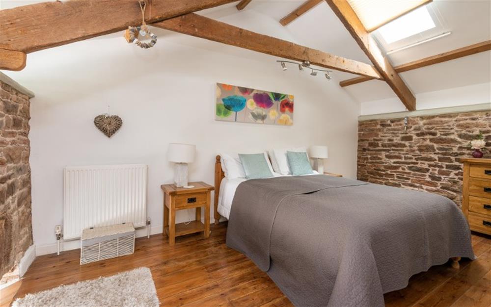 Master bedroom with exposed beams  at 1 Alston Farm Cottage in Churston Ferrers