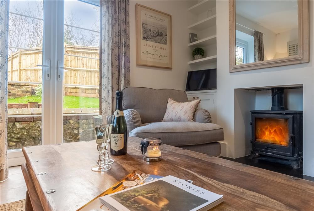 Ground floor sitting room with wood burning stove at 1 Church Cottages and Garden Room, Westmeston