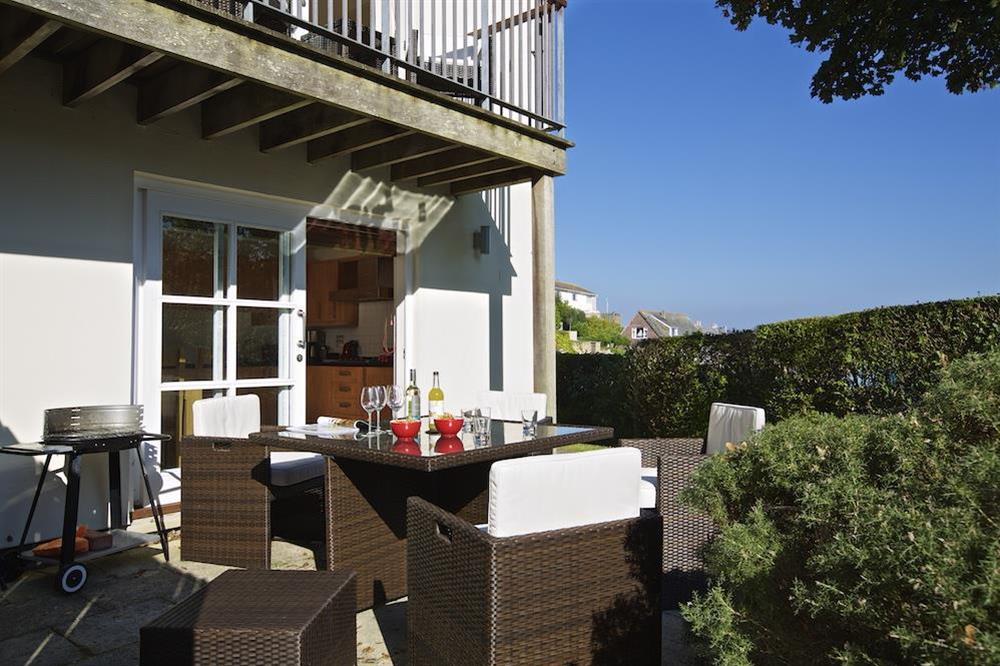 Terrace with glass-topped rattan table and chairs at 1 Combehaven in , Salcombe