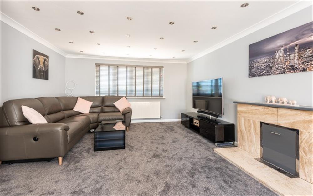 the modern lounge with reclining sofa at 1 Crestfields in Strete