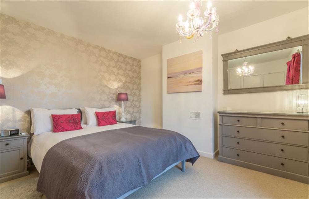 First floor: Master bedroom with King-size bed at 1 Dix Cottages, Thornham near Hunstanton