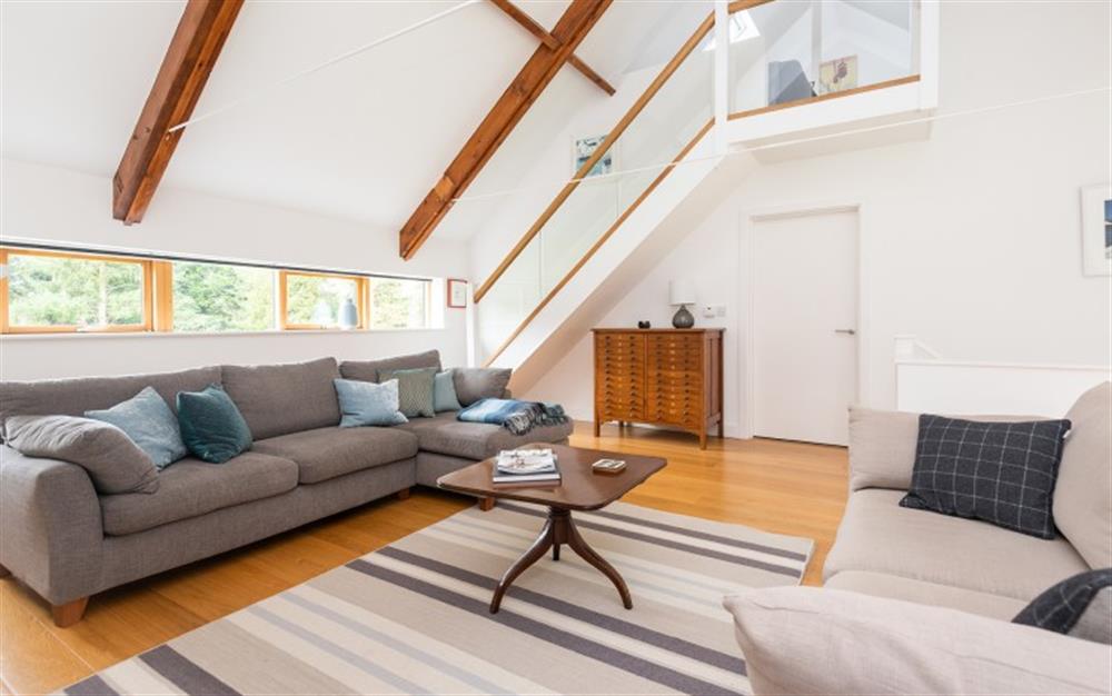 High vaulted ceilings in the sitting room with stairs leading to mezzanine snug. at 1 Dufour in East Allington