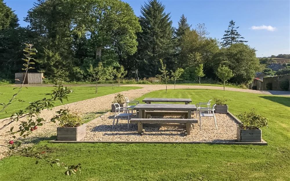 Open communal seating area just a short step from the back door and overlooking a small orchard and large lawns. at 1 Dufour in East Allington