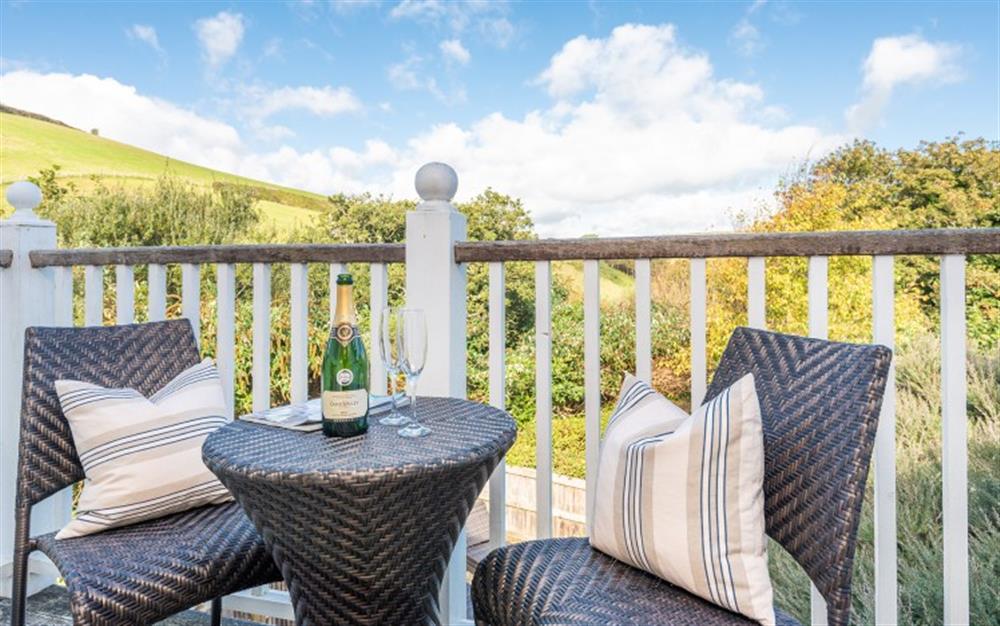 Relaxing with a glass of fizz and superb views at 1 Edith Mews in Hallsands