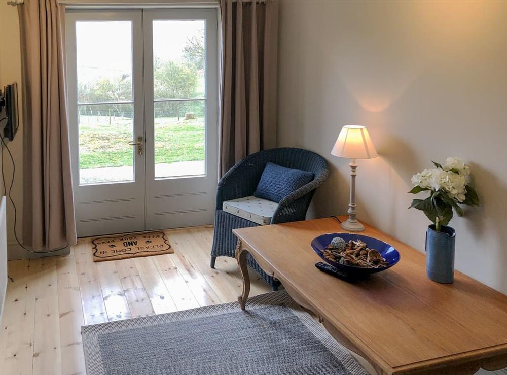 Comfy sitting room with french doors at 1 Gill Edge Cottages in Bainbridge, near Hawes, North Yorkshire