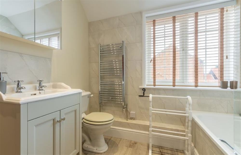 First floor: Family bathroom with shower over bath, WC, hand basin and heated towel rail at 1 Hall Lane Cottages, Thornham  near Hunstanton