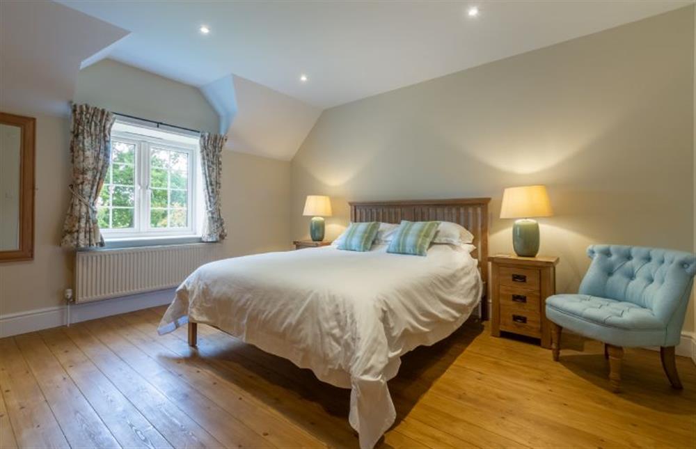 First floor: Master bedroom with king-size bed and Freeview TV  at 1 Hall Lane Cottages, Thornham  near Hunstanton
