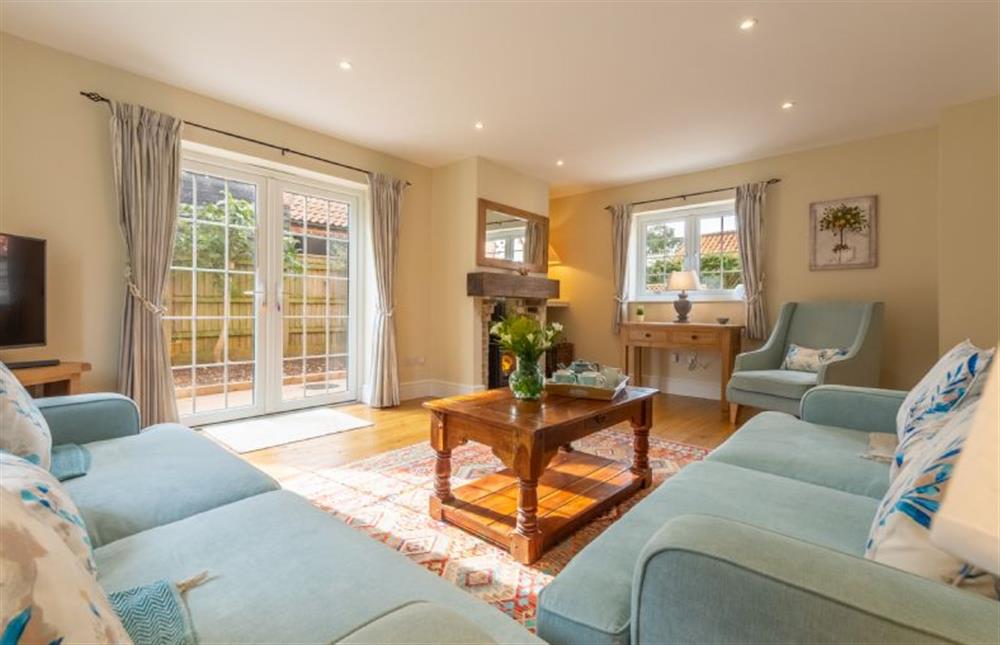 Ground floor: Bright sitting room with french doors to the garden at 1 Hall Lane Cottages, Thornham  near Hunstanton