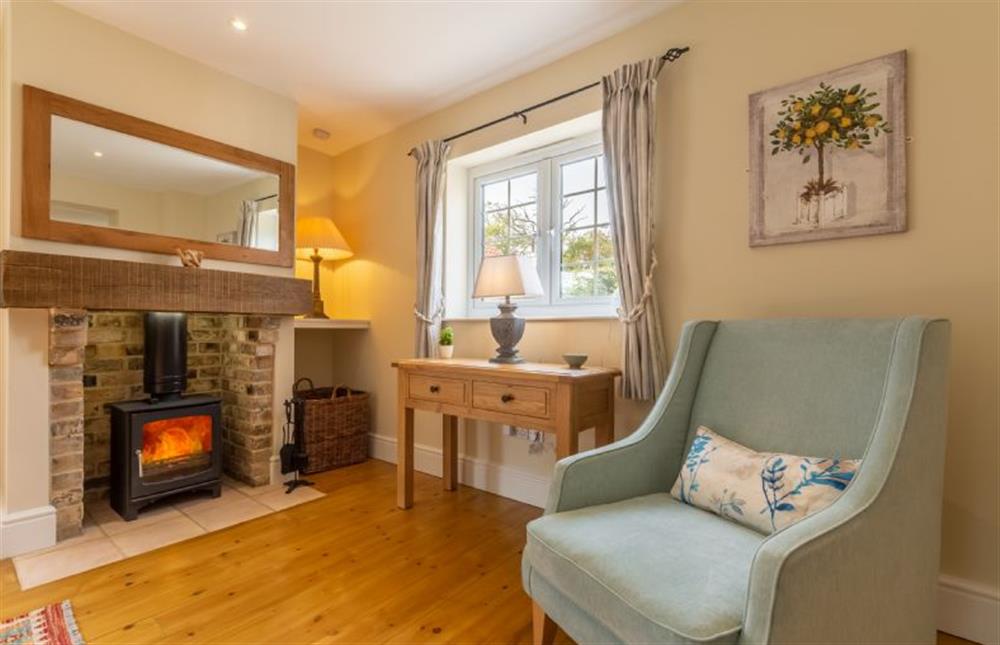 Ground floor: Cosy wood burning stove in the sitting room at 1 Hall Lane Cottages, Thornham  near Hunstanton