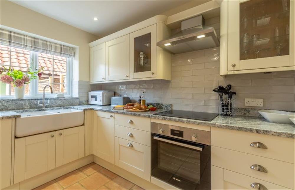 Ground floor: Kitchen with double Belfast sink, electric cooker and hob, microwave, fridge/freezer and dishwasher