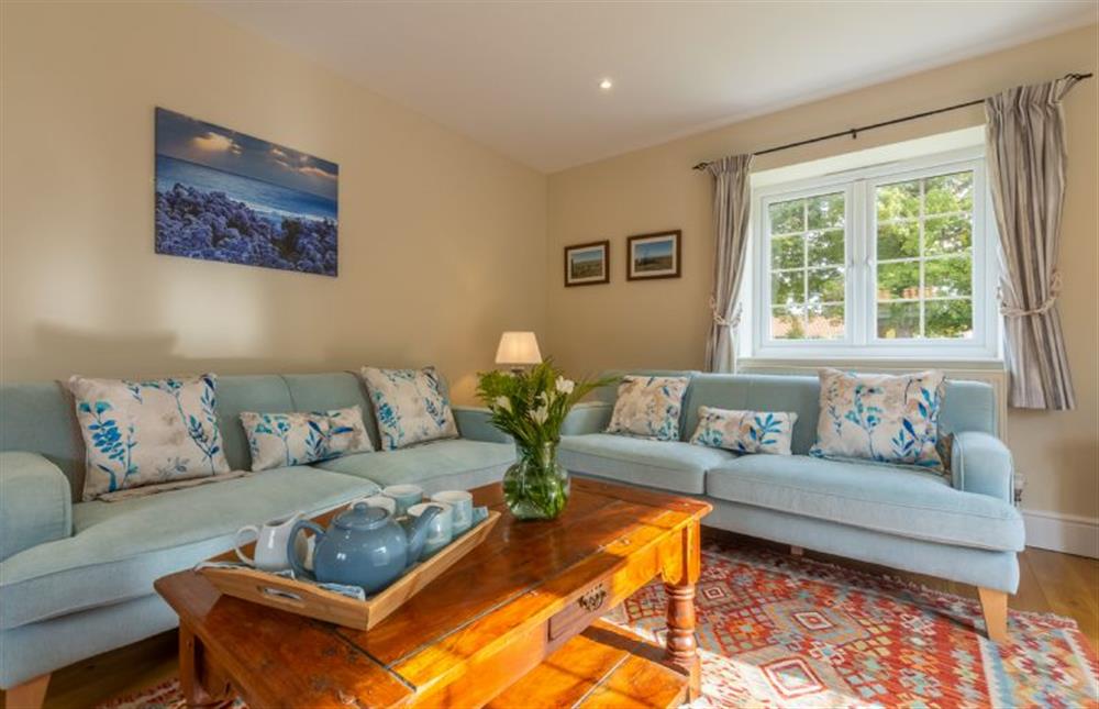 Ground floor: Sitting room with wood burning stove, two sofas, arm chair, Freeview Smart TV  at 1 Hall Lane Cottages, Thornham  near Hunstanton