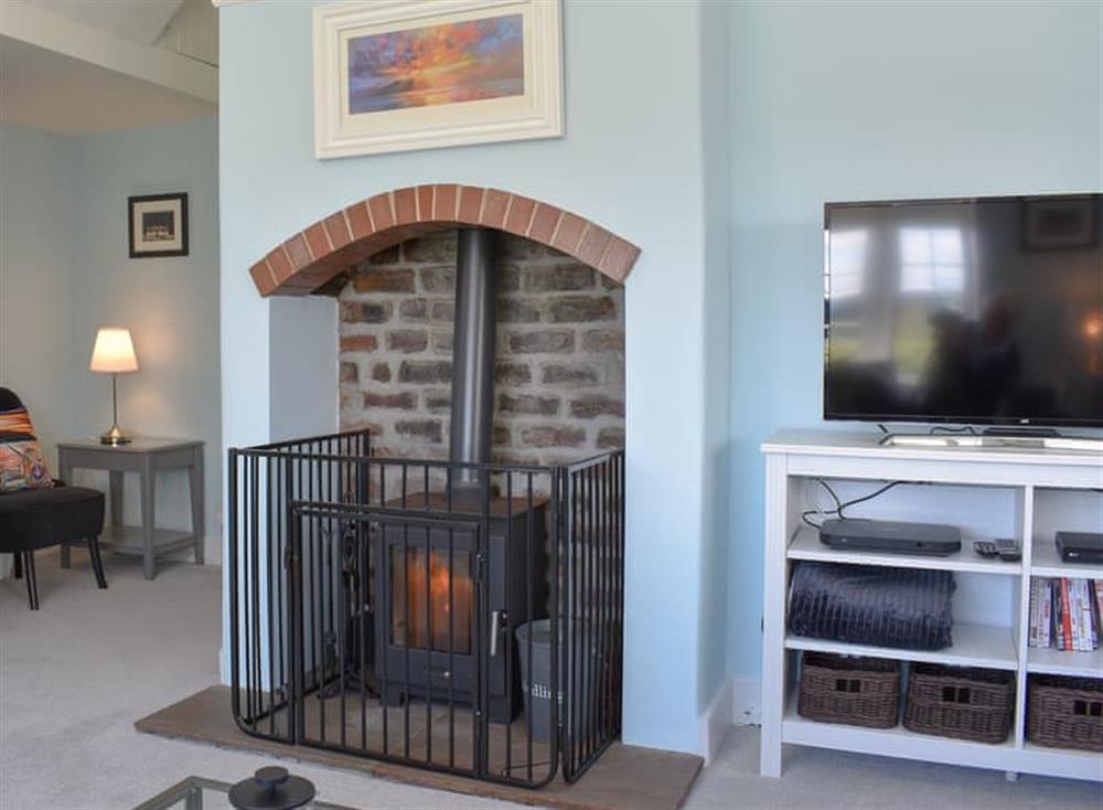 Cosy living room with wood burner at 1 Hamilton Terrace in Lamlash, Isle of Arran, Scotland