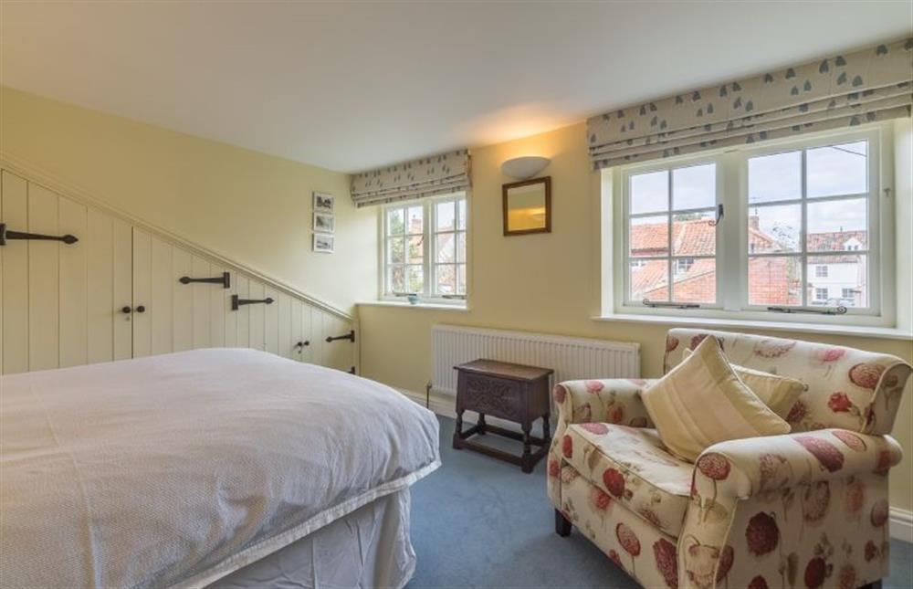 First floor: Master bedroom with double bed and sofa at 1 Honeymoon Row, Wells-next-the-Sea