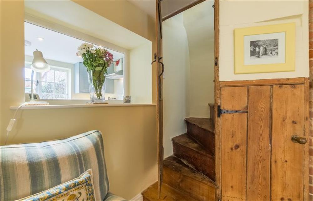 Ground floor: Sitting room with Norfolk winder stairs leading to the first floor at 1 Honeymoon Row, Wells-next-the-Sea