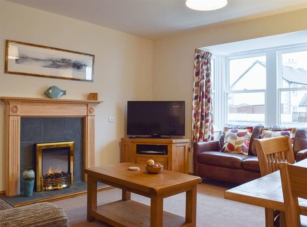 Delightful living room with feature fireplace at 1 Lonsdale House in Keswick, Cumbria