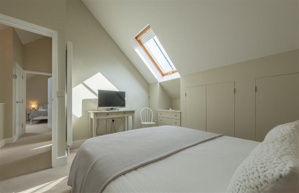 First Floor: Master bedroom with television at 1 Railway Cottages, Holt