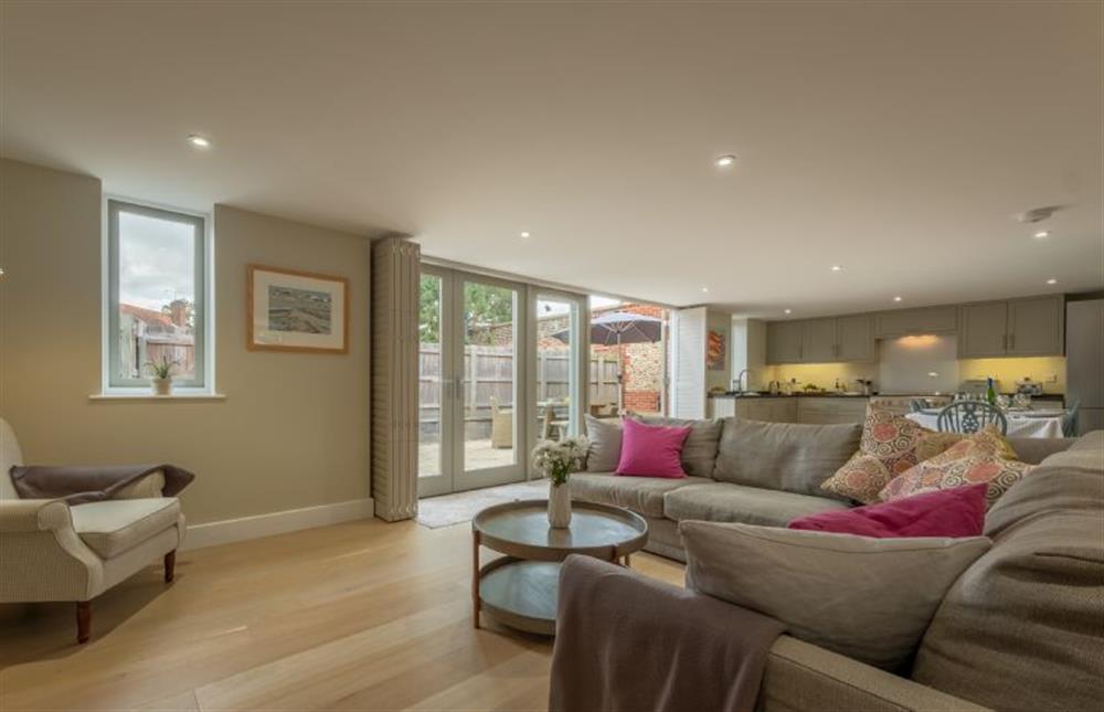 Ground floor: Sitting room with french doors leading to the enclosed garden at 1 Railway Cottages, Holt