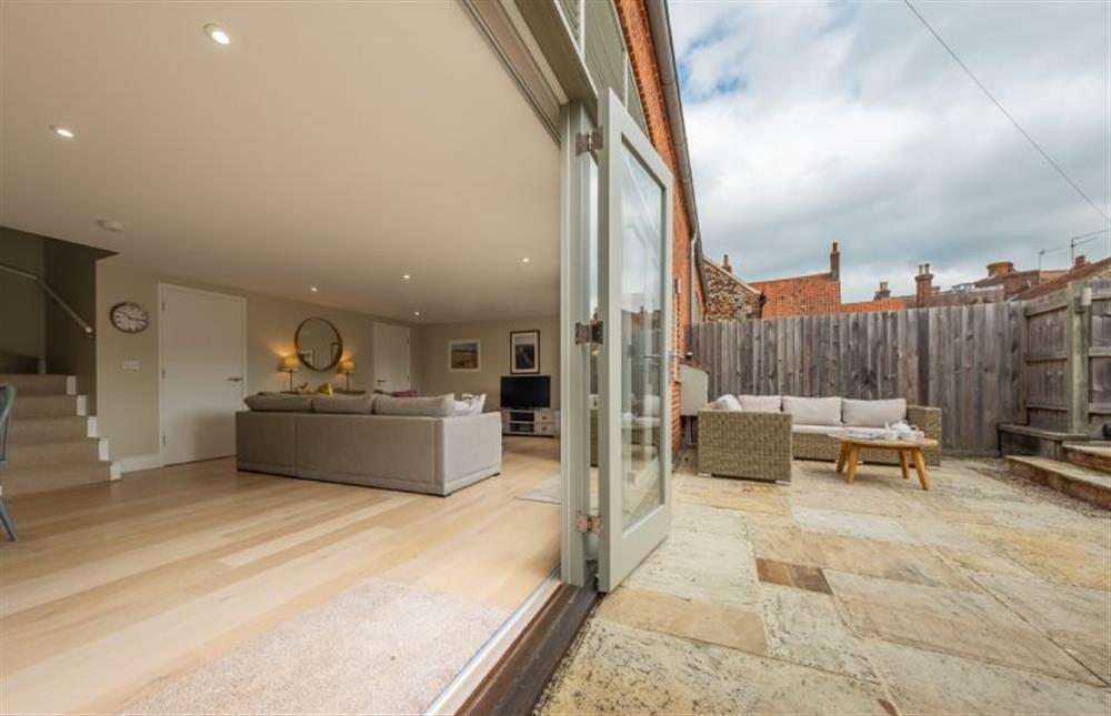 Ground floor: The sitting room spills in to the enclosed courtyard at 1 Railway Cottages, Holt