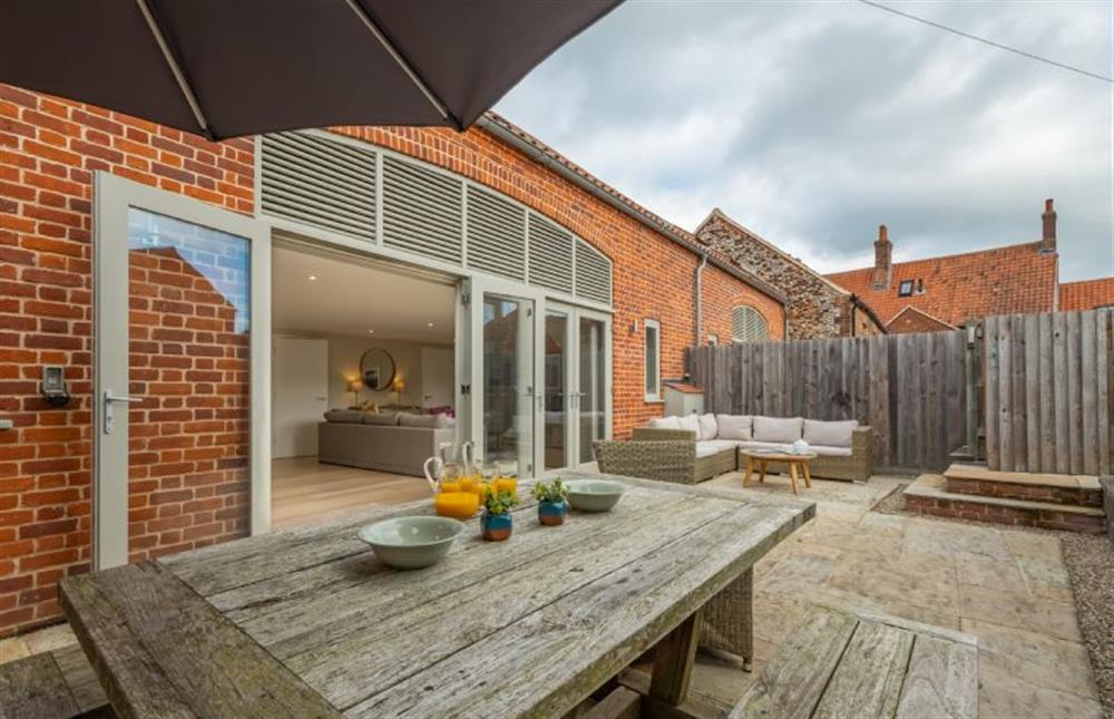 Outdoor dining and seating areas at 1 Railway Cottages, Holt