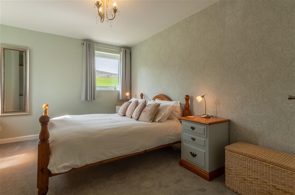 Bedroom one with 5’ king-size bed and stunning views at 1 Riverside Cottage, Burnsall