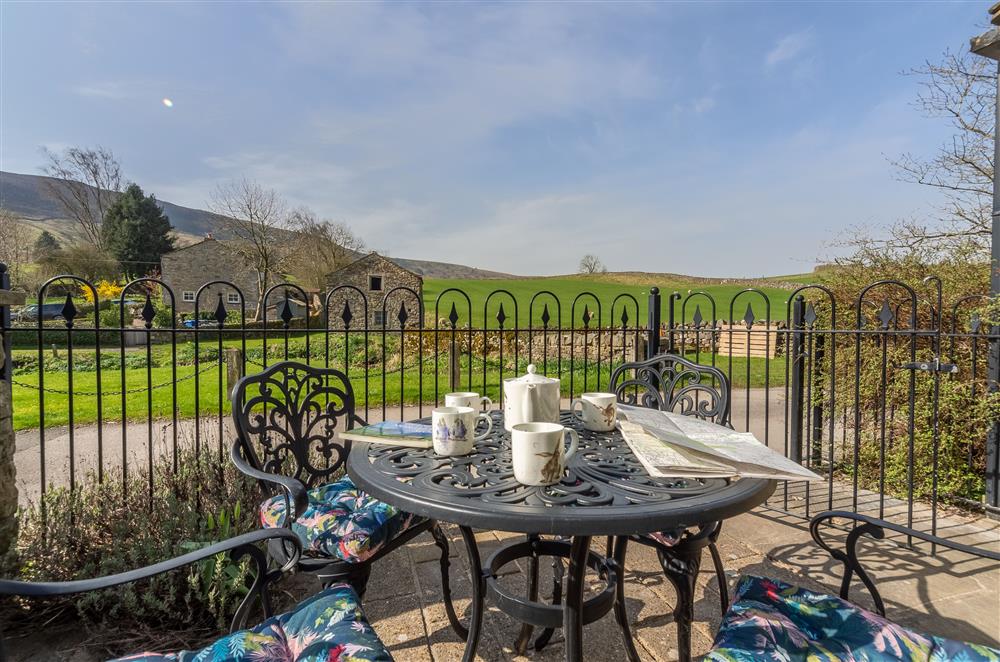 Patio seating area and a beautiful view at 1 Riverside Cottage, Burnsall