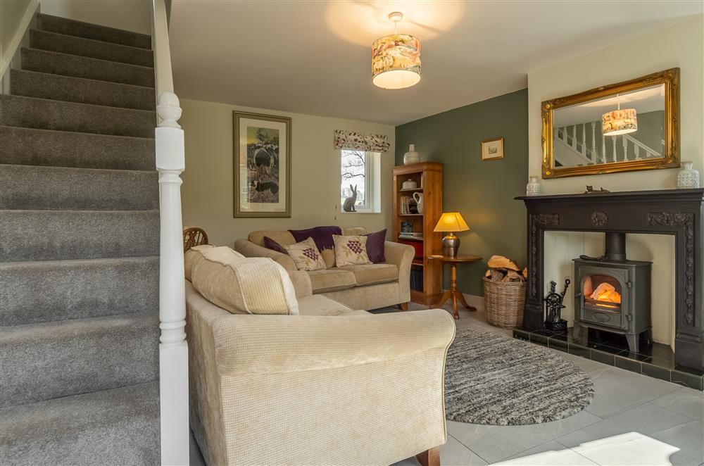 Sitting room with staircase to first floor at 1 Riverside Cottage, Burnsall