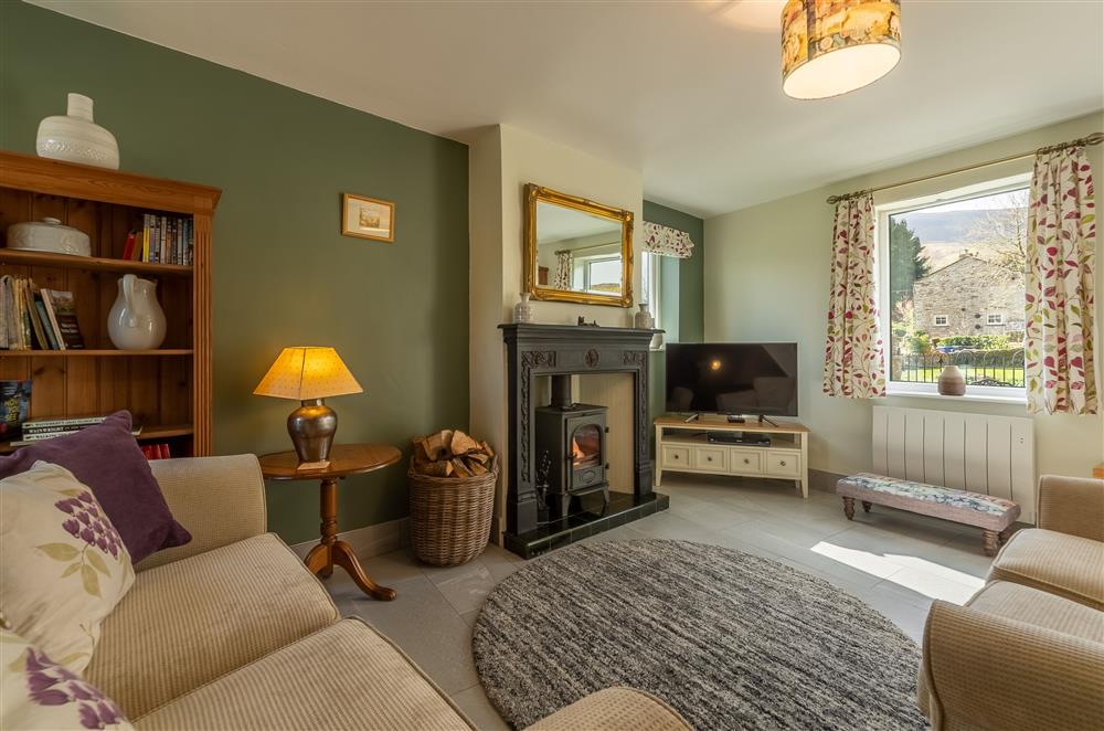 Sitting room with wood burning stove at 1 Riverside Cottage, Burnsall