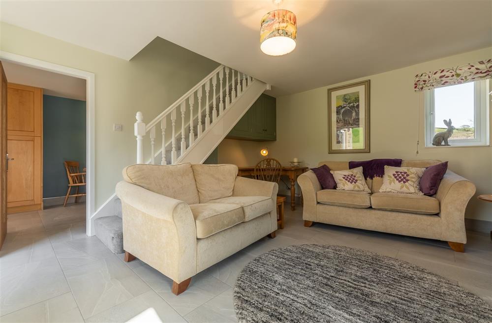 Sitting room with staircase to first floor at 1 Riverside Cottages, Skipton, North Yorkshire