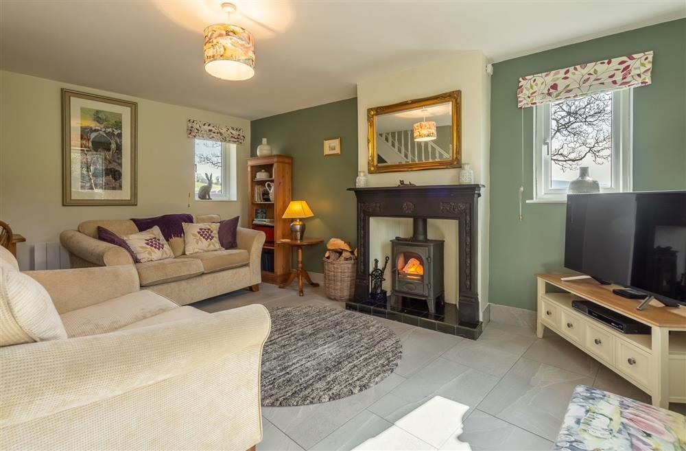 Sitting room with wood-burning stove at 1 Riverside Cottages, Skipton, North Yorkshire
