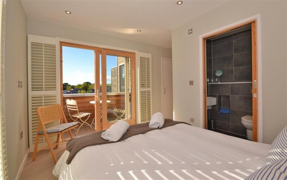 The master bedroom showing the private balcony at 1 Talland in Talland Bay