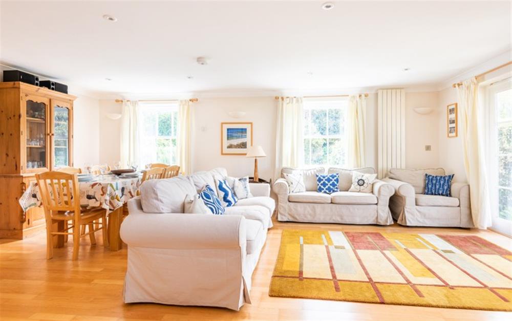 The bright sitting room, with doors to the patio  at 1 Thurlestone Beach Apartments in Thurlestone