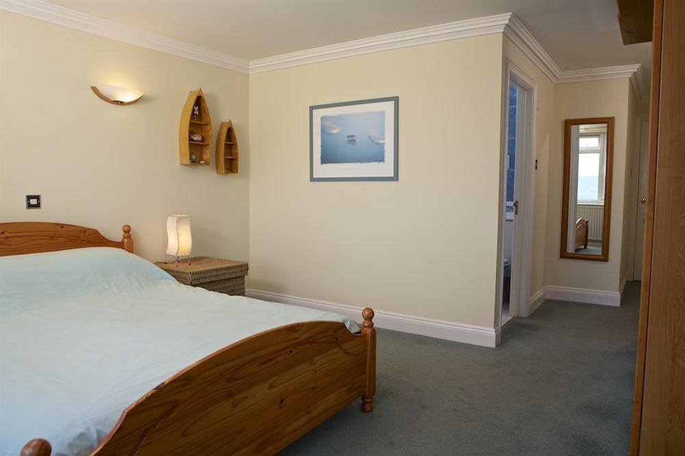 Master bedroom with King size bed and en suite bathroom at 1 Thurlestone Rock Apartments in Thurlestone, Kingsbridge