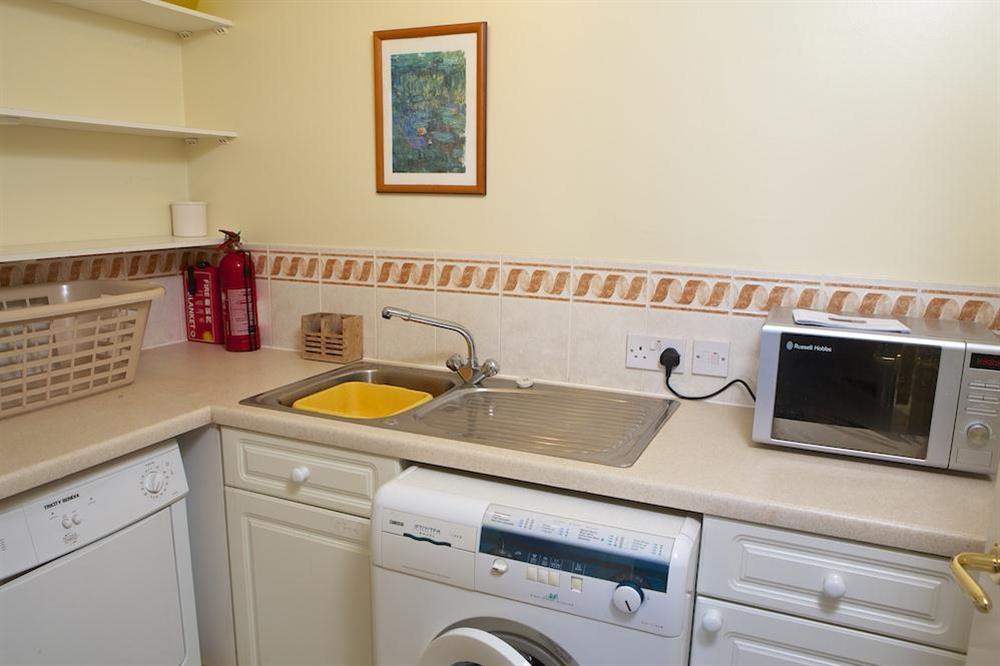 Utility room with washing machine and tumble dryer at 1 Thurlestone Rock Apartments in Thurlestone, Kingsbridge