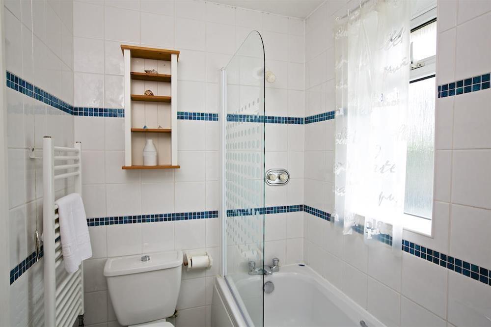 Family bathroom with bath and overhead shower at 1 Top View Cottages in Bonaventure Road, Salcombe