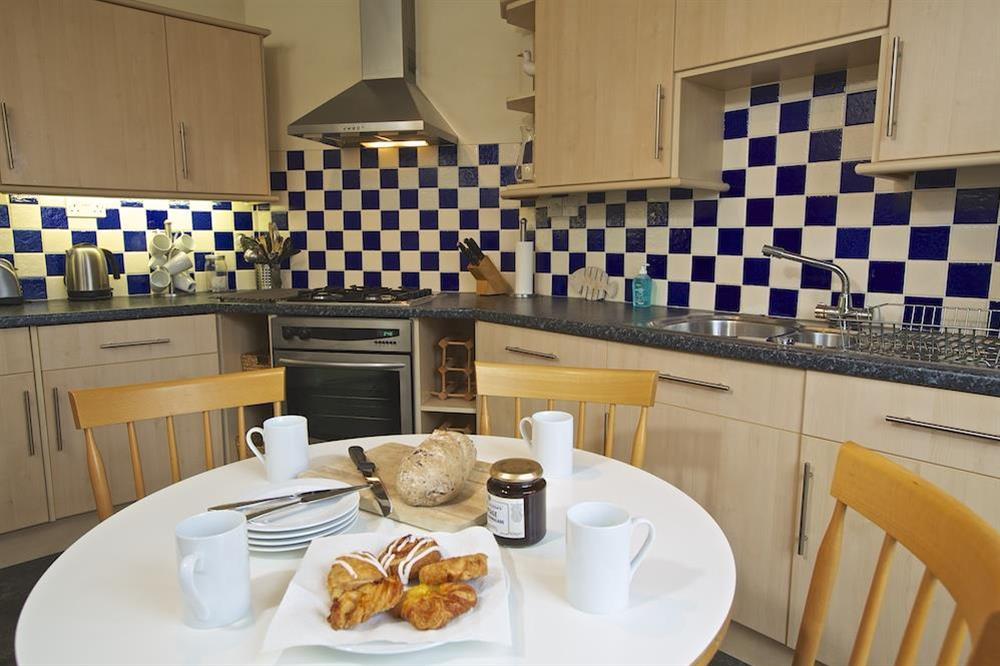 Kitchen area with circular breakfast table at 1 Top View Cottages in Bonaventure Road, Salcombe