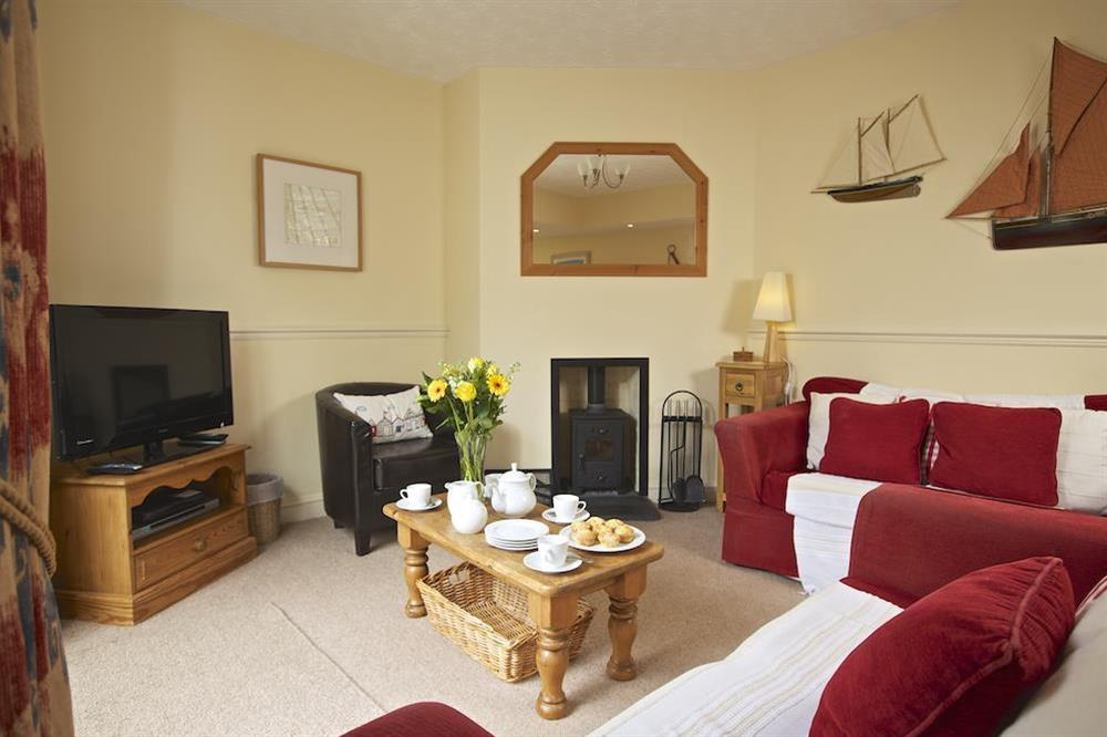 Lovely lounge area with woodburning stove at 1 Top View Cottages in Bonaventure Road, Salcombe