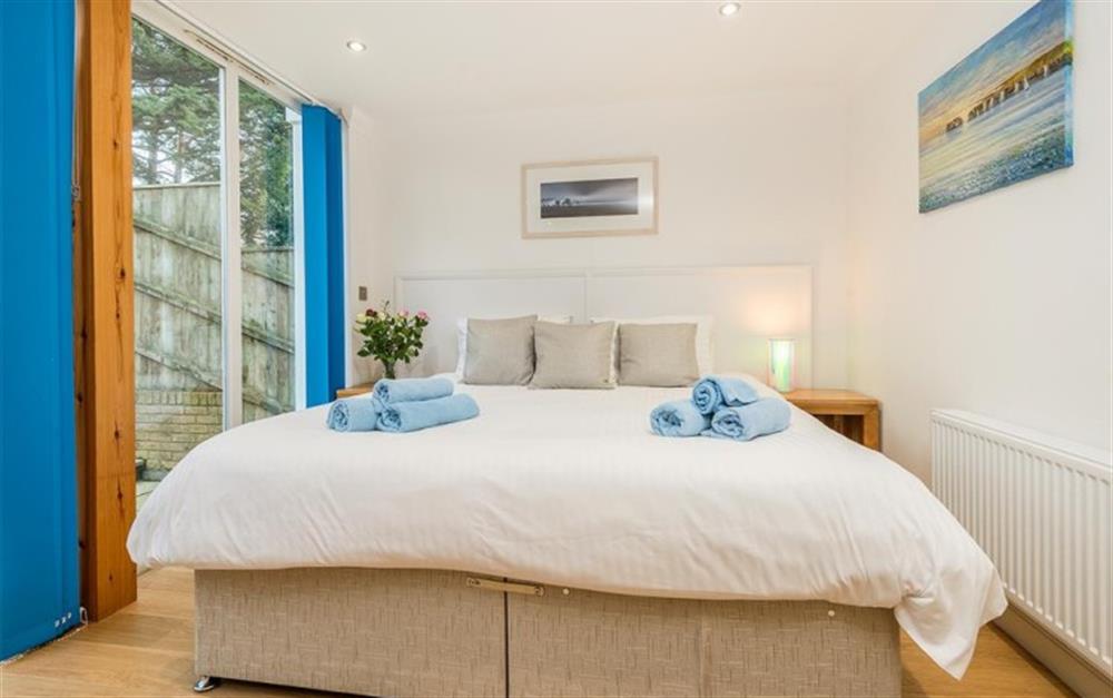 Bedroom 2 with access to the garden at 1 West Point in Sandbanks