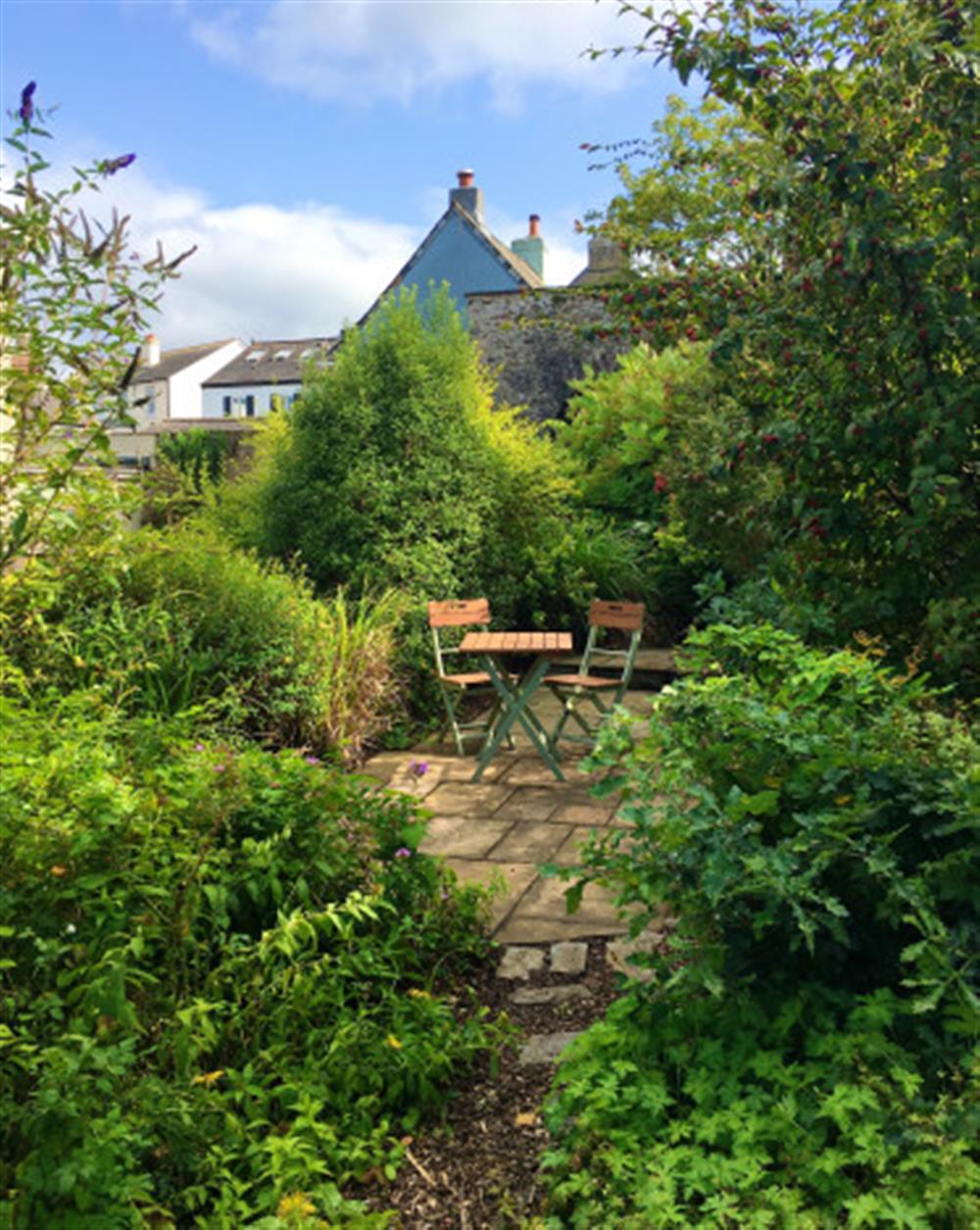 There are various seating areas within the large garden. at 10 Castle Street in Totnes
