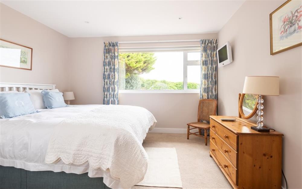 Master bedroom with king size bed  at 10 Old Rectory Gardens in Thurlestone