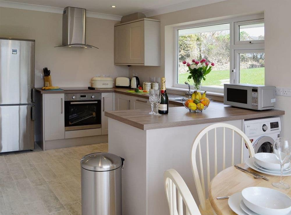 Modern well equipped kitchen with dining area at 10 Silvershell View in Port Isaac, Cornwall