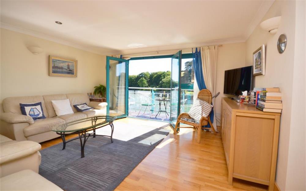 The lounge area with access to balcony at 11 Crabshell Quay in Kingsbridge