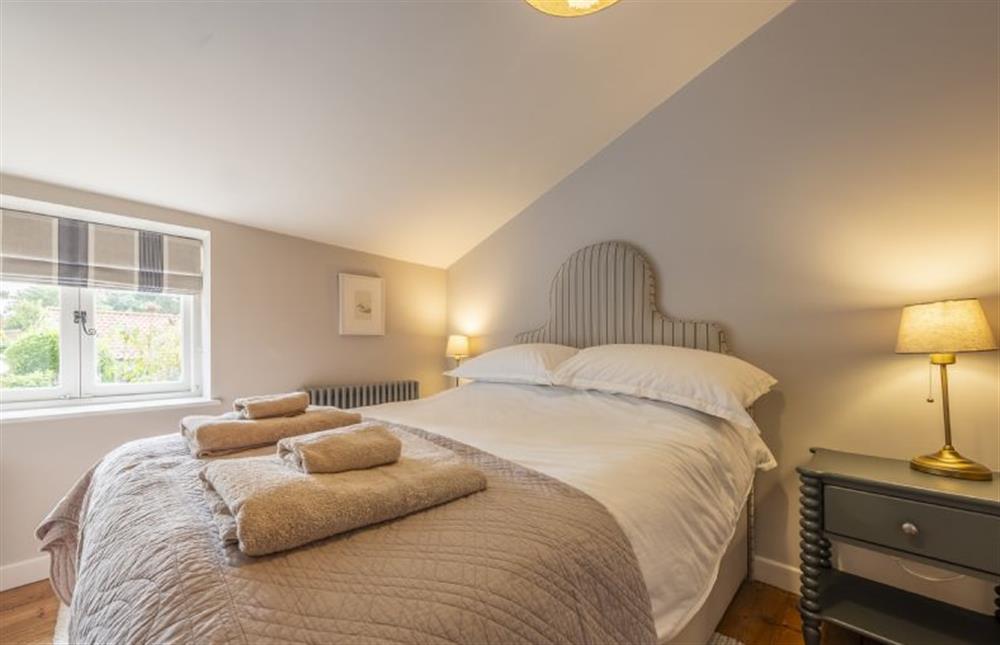 Master bedroom with a double bed at 12 Station Road, Holt