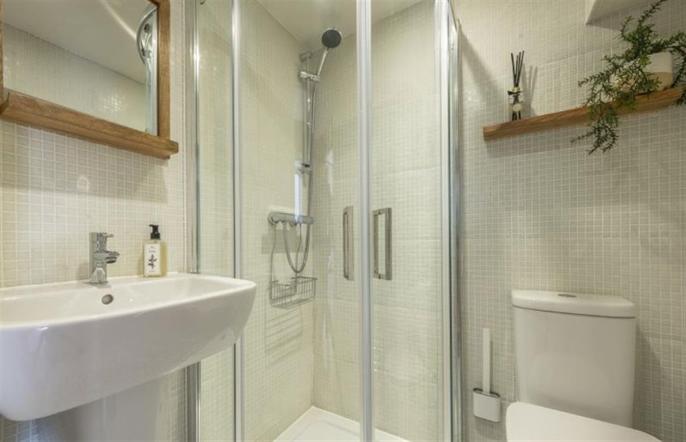 Shower room with corner shower, wash basin, WC and heated towel rail at 12 Station Road, Holt