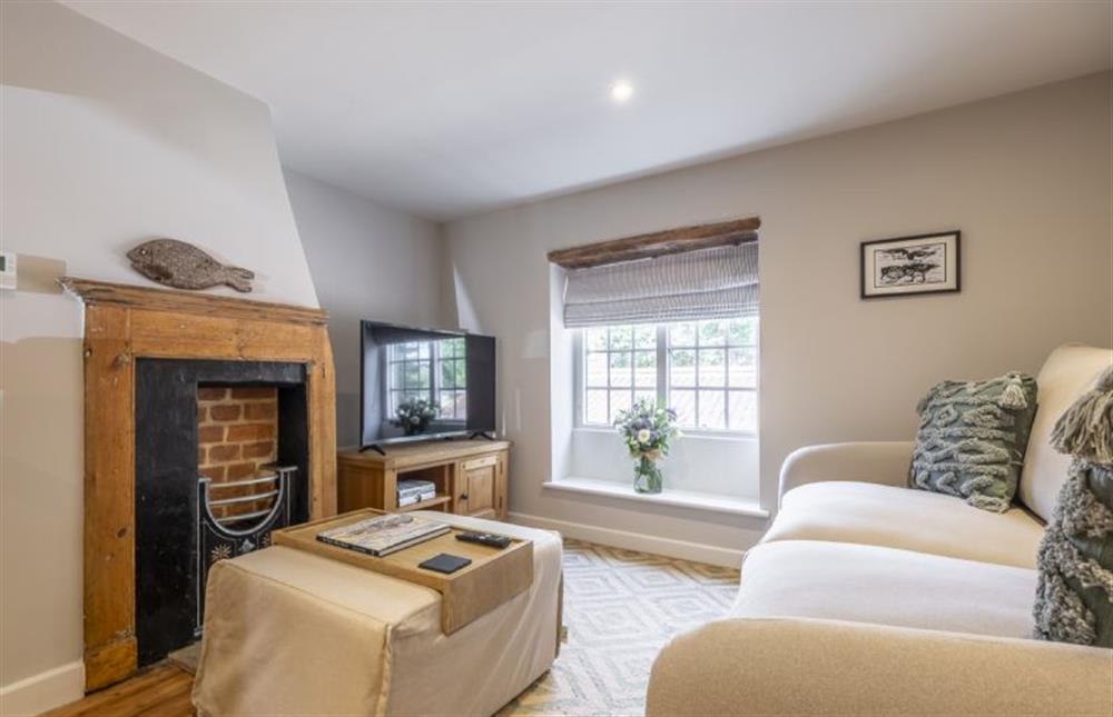 Sitting room with ornamental fireplace at 12 Station Road, Holt