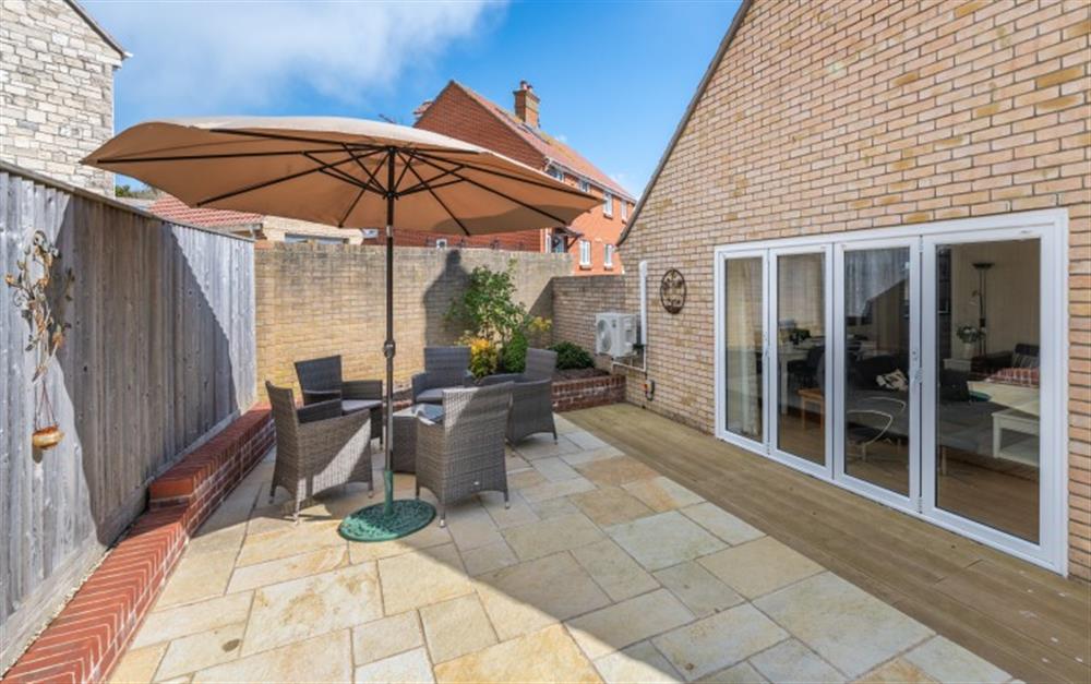 Sheltered patio to relax outside at 13 Foxglove Way in West Bay