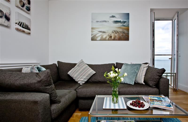 Relax in the living area at 14 At The Beach, Devon