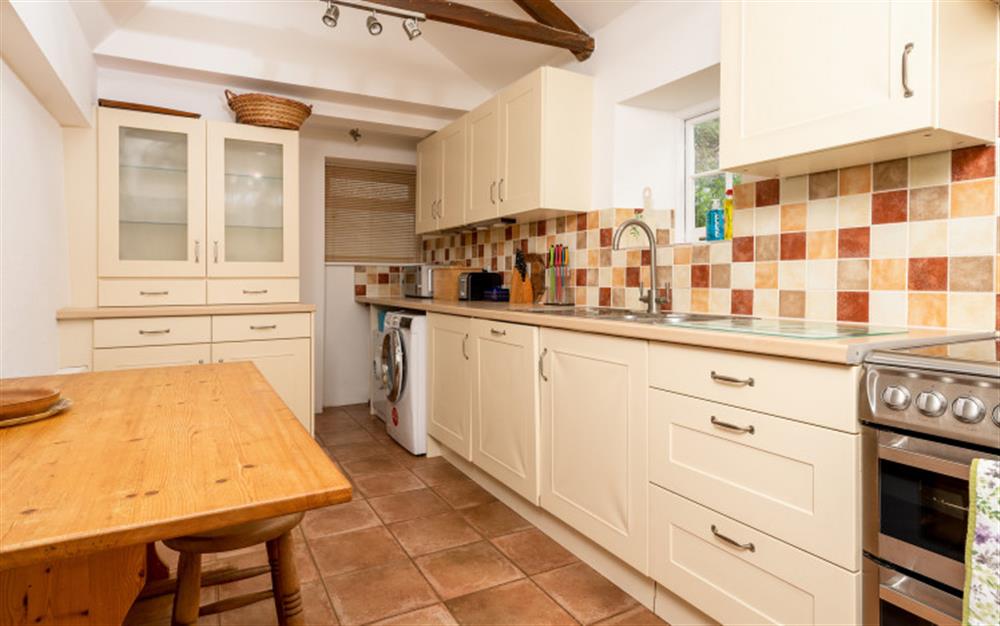 The farmhouse kitchen with table and stools at 14 Beesands in Beesands