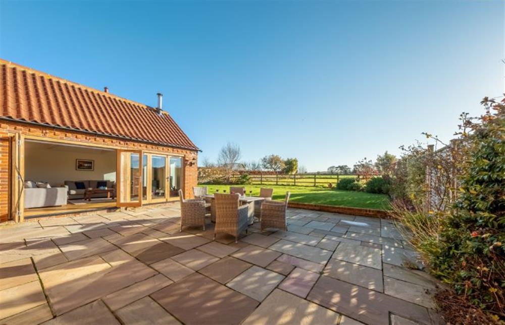 A large patio with dining area at 14 Burnham Road, Ringstead near Hunstanton