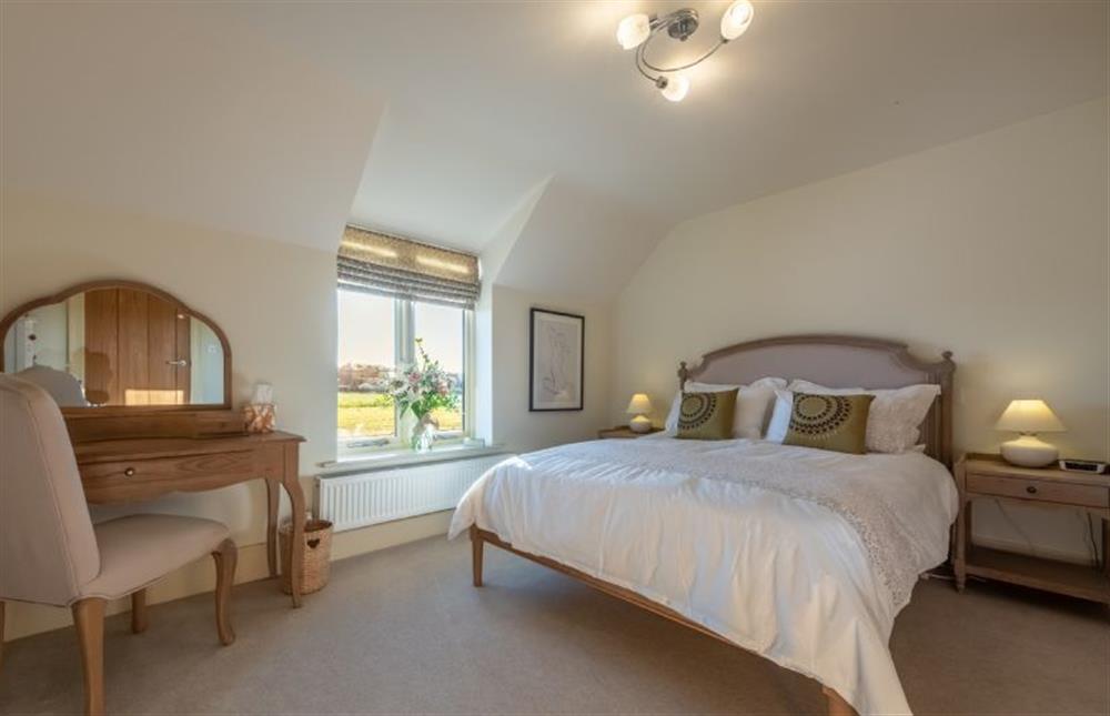 First floor: A master bedroom with views across the fields at 14 Burnham Road, Ringstead near Hunstanton