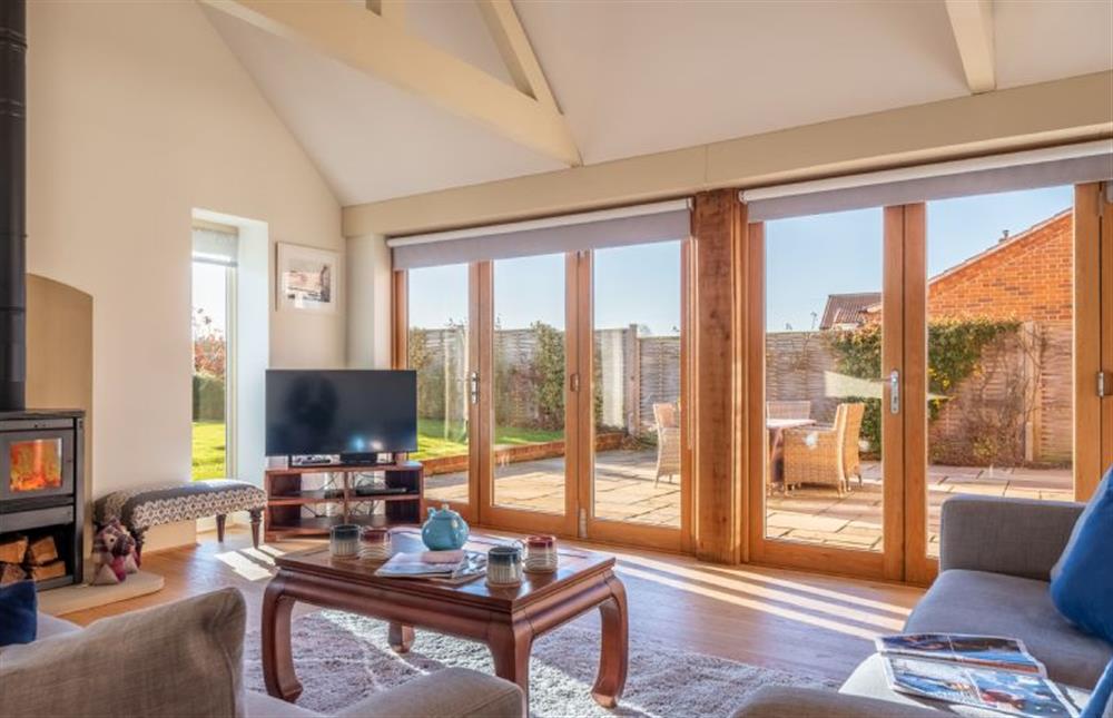 Ground floor: Sitting room with wood burning stove and Sky television at 14 Burnham Road, Ringstead near Hunstanton